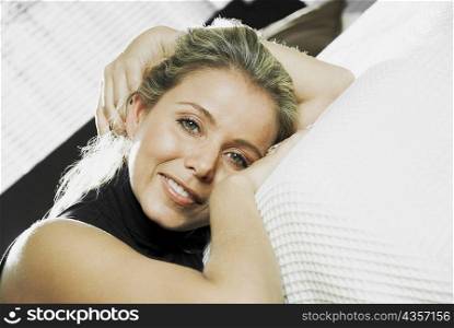 Portrait of a mid adult woman reclining on the bed