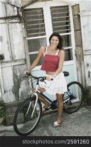 Portrait of a mid adult woman riding a bicycle and smiling