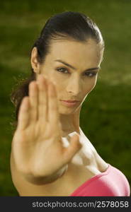 Portrait of a mid adult woman showing a stop gesture