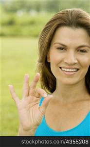 Portrait of a mid adult woman showing an ok sign