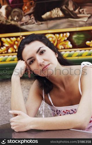 Portrait of a mid adult woman sitting at a table in a restaurant