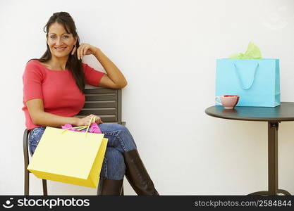 Portrait of a mid adult woman sitting in an armchair and smiling