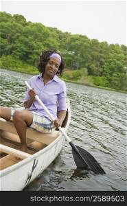 Portrait of a mid adult woman sitting on a boat and smiling
