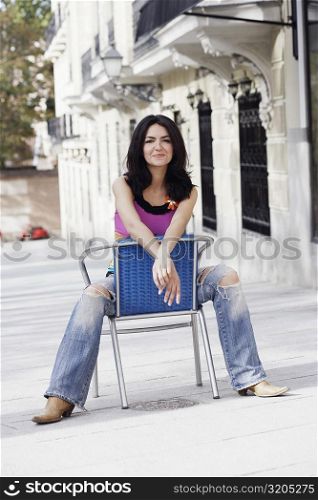 Portrait of a mid adult woman sitting on a chair