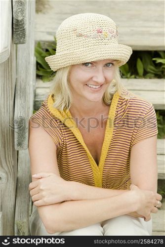 Portrait of a mid adult woman sitting on steps and smiling