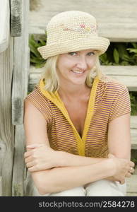 Portrait of a mid adult woman sitting on steps and smiling