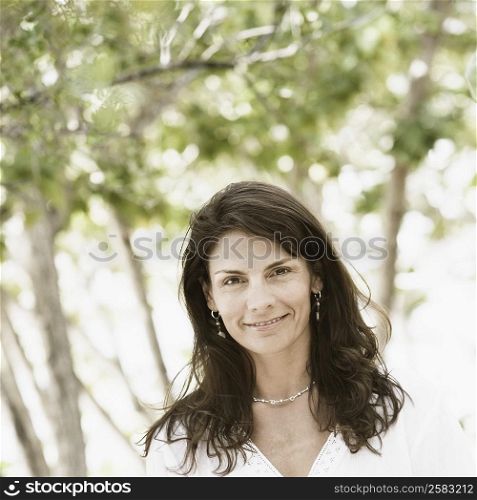 Portrait of a mid adult woman standing on the beach and smiling
