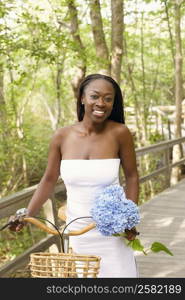 Portrait of a mid adult woman standing with a bicycle