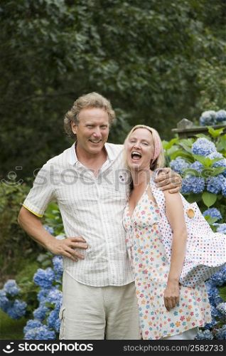 Portrait of a mid adult woman standing with a mature man and laughing