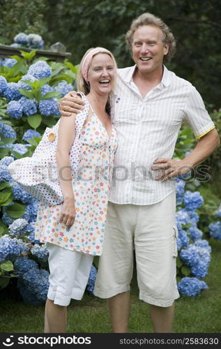 Portrait of a mid adult woman standing with a mature man and laughing