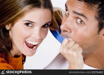 Portrait of a mid adult woman sticking an adhesive tape on a young man&acute;s mouth
