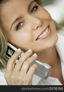 Portrait of a mid adult woman talking on a mobile phone and smiling