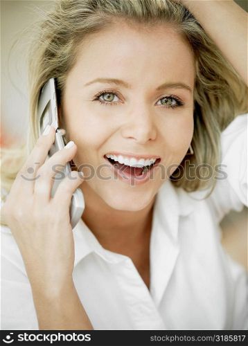 Portrait of a mid adult woman talking on a mobile phone and smiling