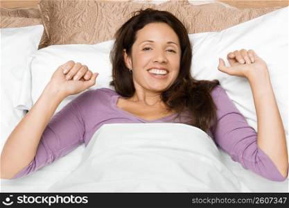 Portrait of a mid adult woman waking up and smiling