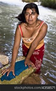 Portrait of a mid adult woman washing clothes, Agua Azul Cascades, Chiapas, Mexico