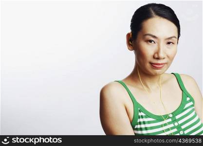 Portrait of a mid adult woman wearing headphones and listening to music