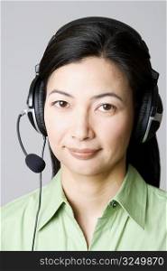 Portrait of a mid adult woman with a headset on her ear