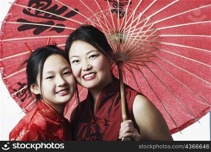 Portrait of a mother and her daughter smiling