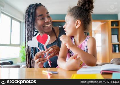 Portrait of a mother and her daughter smiling and spending time together while staying at home. Monoparental concept. New normal lifestyle concept.