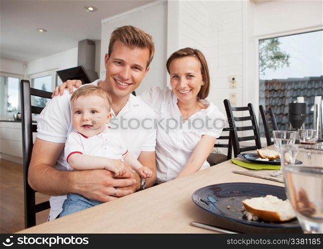 Portrait of a mother father and son after eating in a home interior