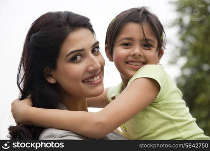 Portrait of a mother holding her daughter