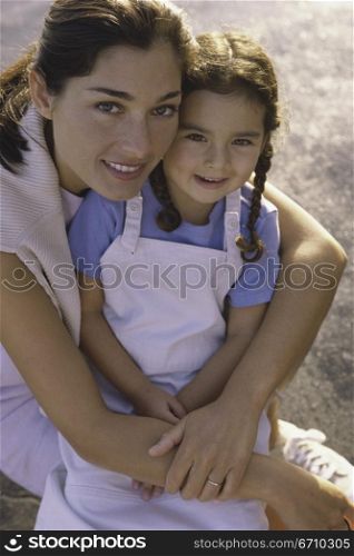 Portrait of a mother holding her daughter