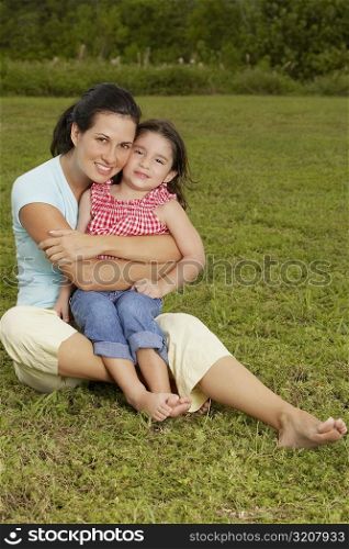 Portrait of a mother hugging her daughter from behind