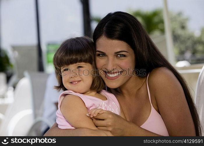 Portrait of a mother with her daughter smiling