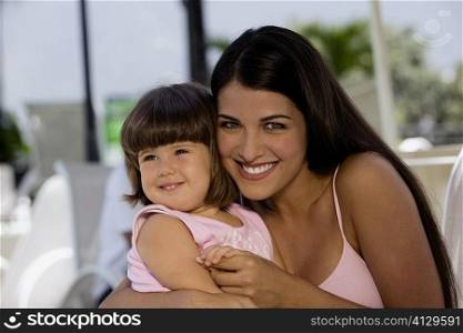Portrait of a mother with her daughter smiling
