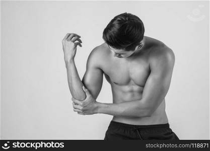 Portrait of a muscle man having elbow pain isolated on white background. Portrait of a muscle man having elbow pain isolated on white bac