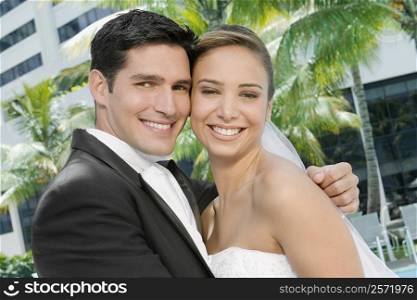 Portrait of a newlywed couple embracing each other