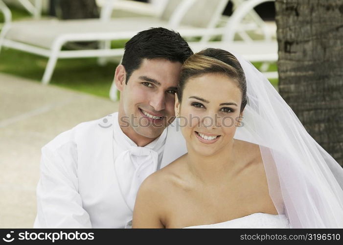 Portrait of a newlywed couple smiling