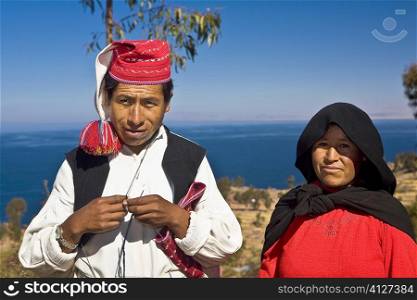 Portrait of a newlywed young couple standing, Taquile Island, Lake Titicaca, Puno, Peru