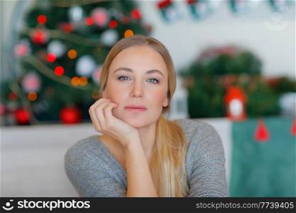 Portrait of a Nice Blond Female at Home near Decorated Christmas Tree. Happy Winter Holidays at Home. Enjoying Christmastime.. Pretty Girl on Christmas Eve
