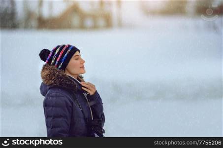 Portrait of a Nice Female Enjoying Snowfall. Having Fun in Cold Winter Weather. Happy Life.. Female Enjoying Snowfall