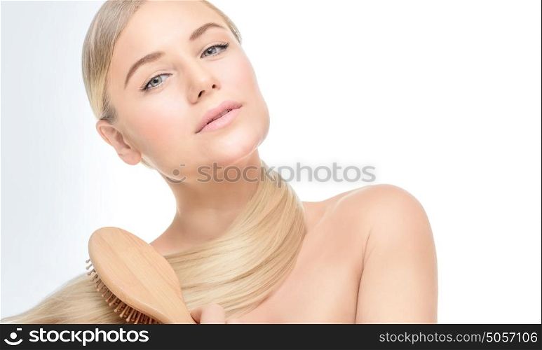 Portrait of a nice girl in the beauty salon, fashion model wearing natural makeup, combing hair, healthy strong hair concept, copy space