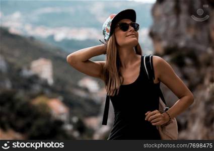 Portrait of a Nice Happy Girl With Backpack Trekking in the Mountains. Active Young Woman Enjoying Travel Among Beautiful Mountainous Nature. 