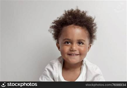 Portrait of a Nice Little African American Boy with Natuiral Afro Hair Style. isolated on Clear Grey Background. Happy Cute Child.