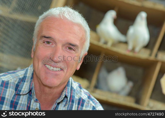 portrait of a pigeon keeper smiling