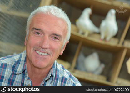 portrait of a pigeon keeper smiling