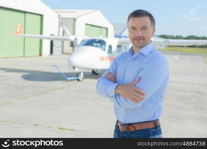 portrait of a pilot beside plane