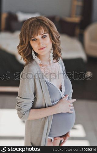 Portrait of a pregnant girl in special underwear.. Maternity underwear with a big belly 1038.. Maternity underwear with a big belly 1038.