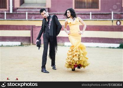 Portrait of a pretty couple, models of fashion, in a bullring. Spanish style