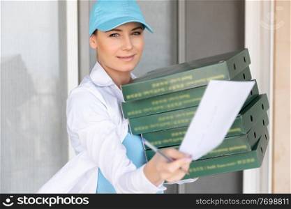 Portrait of a Pretty Girl Wearing Uniform Delivering Pizza to the Customer. Service Occupation. Fast Food. Tasty Eating. Summer Job. Door to Door Delivery.