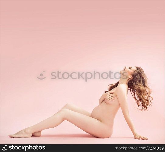 Portrait of a pretty nude pregnant woman