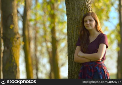 Portrait of a Pretty Teen Girl Standing in a Forest