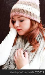 Portrait of a pretty teenage girl with redhair all wrapped up against the cold