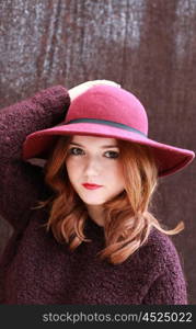 Portrait of a pretty teenage girl with redhair and floppy hat