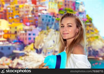 Portrait of a pretty traveler girl enjoying amazing view on a many colorful houses, active summer vacation, enjoying trip to Cinque Terre, Italy, Europe