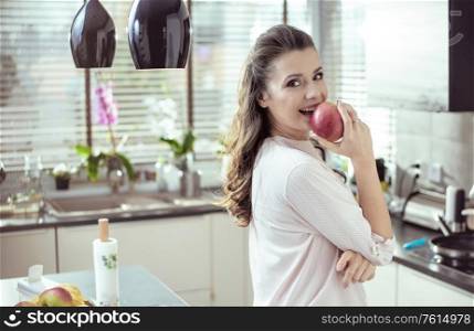 Portrait of a pretty woman biting an apple